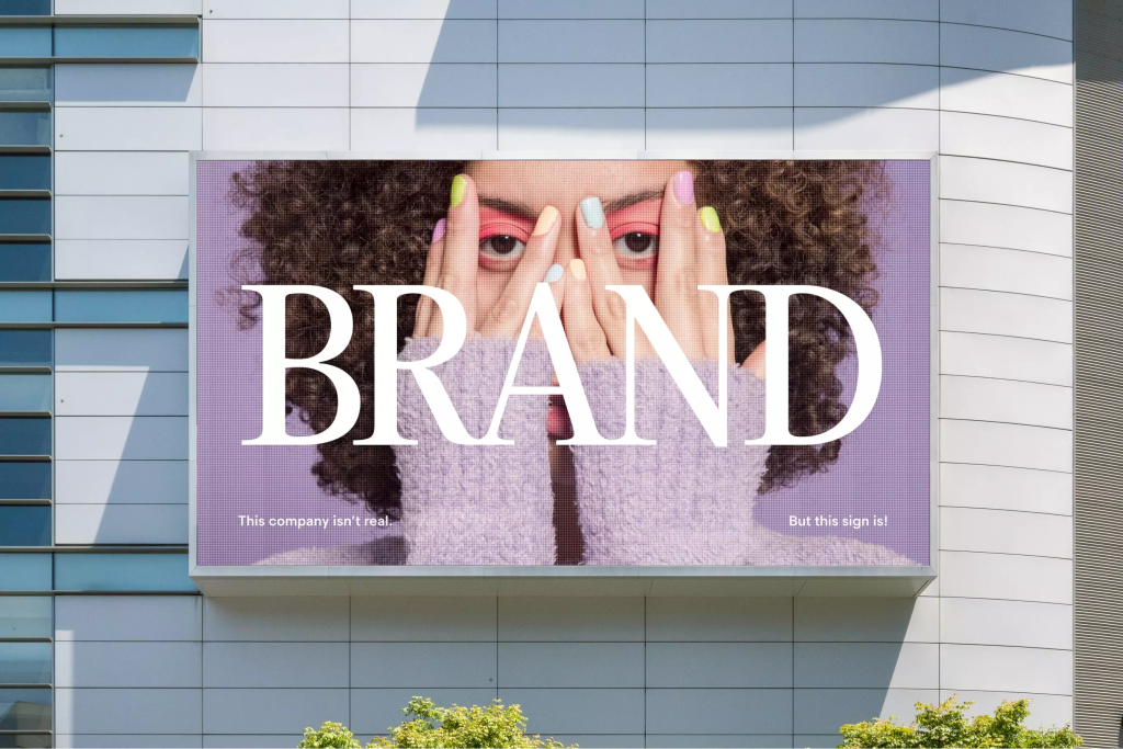 Example of a digital ad. Purple background with a woman's face covered with big white letters spelling out the word "brand".